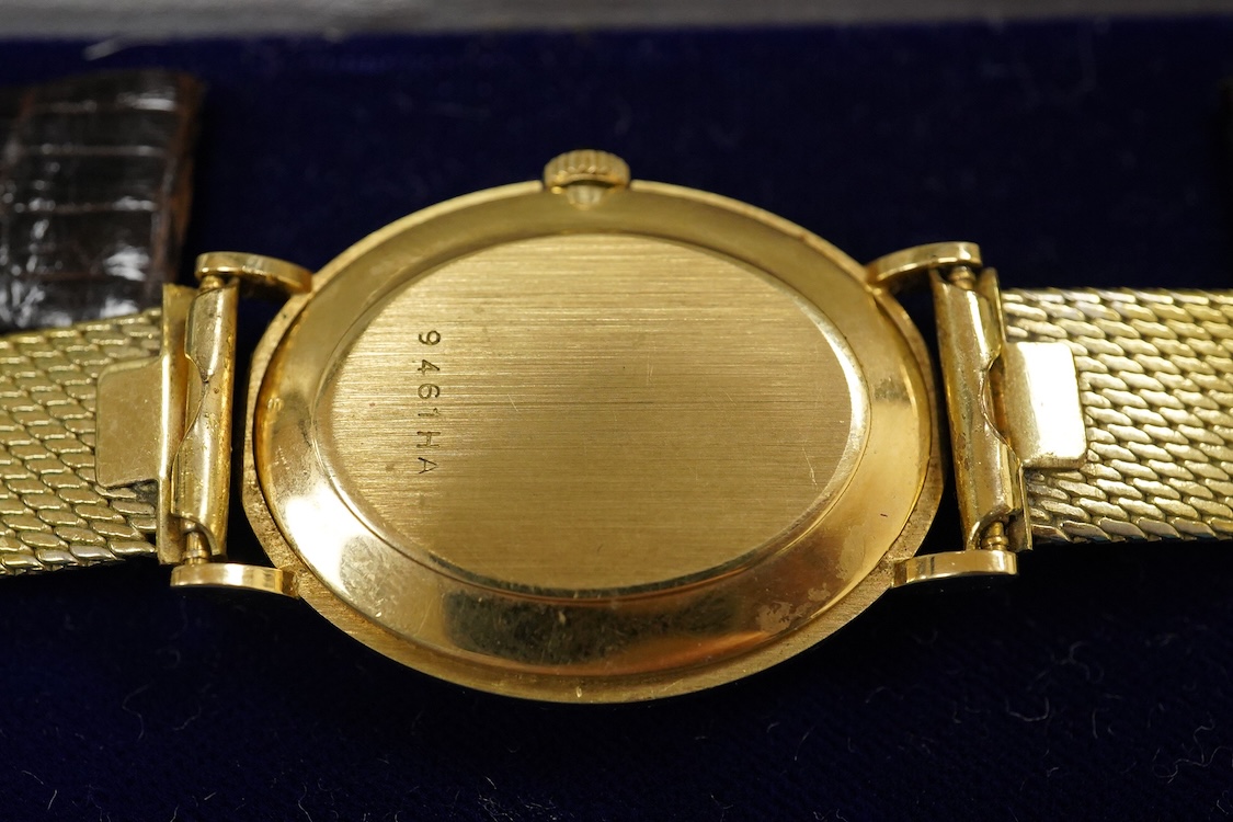 A gentleman's 18ct Girard-Perregaux manual wristwatch, oval brushed gilt dial with raised hour baton marks, seventeen jewels movement, signed, on an associated gilt metal articulated bracelet, in original case.